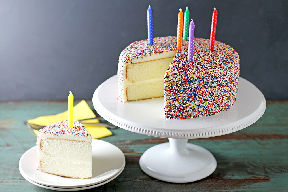 vanilla bean birthday cake with slice on plate