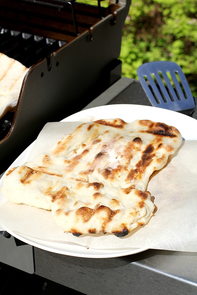 no knead grilled naan next to grill
