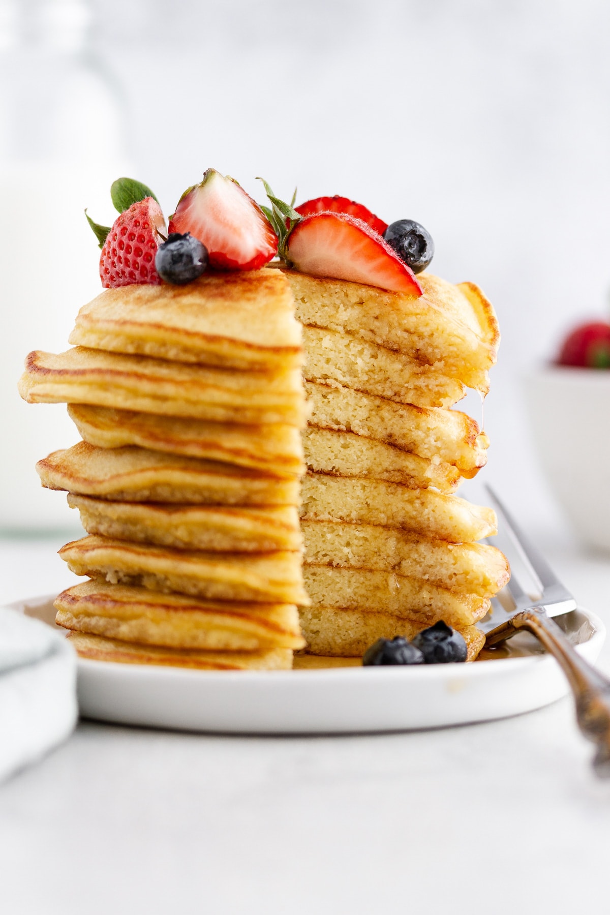 a cross section of a stack of coconut flour pancakes on a plate