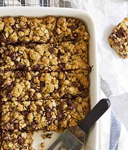 whole wheat oatmeal chocolate chip cookie bars in a baking dish