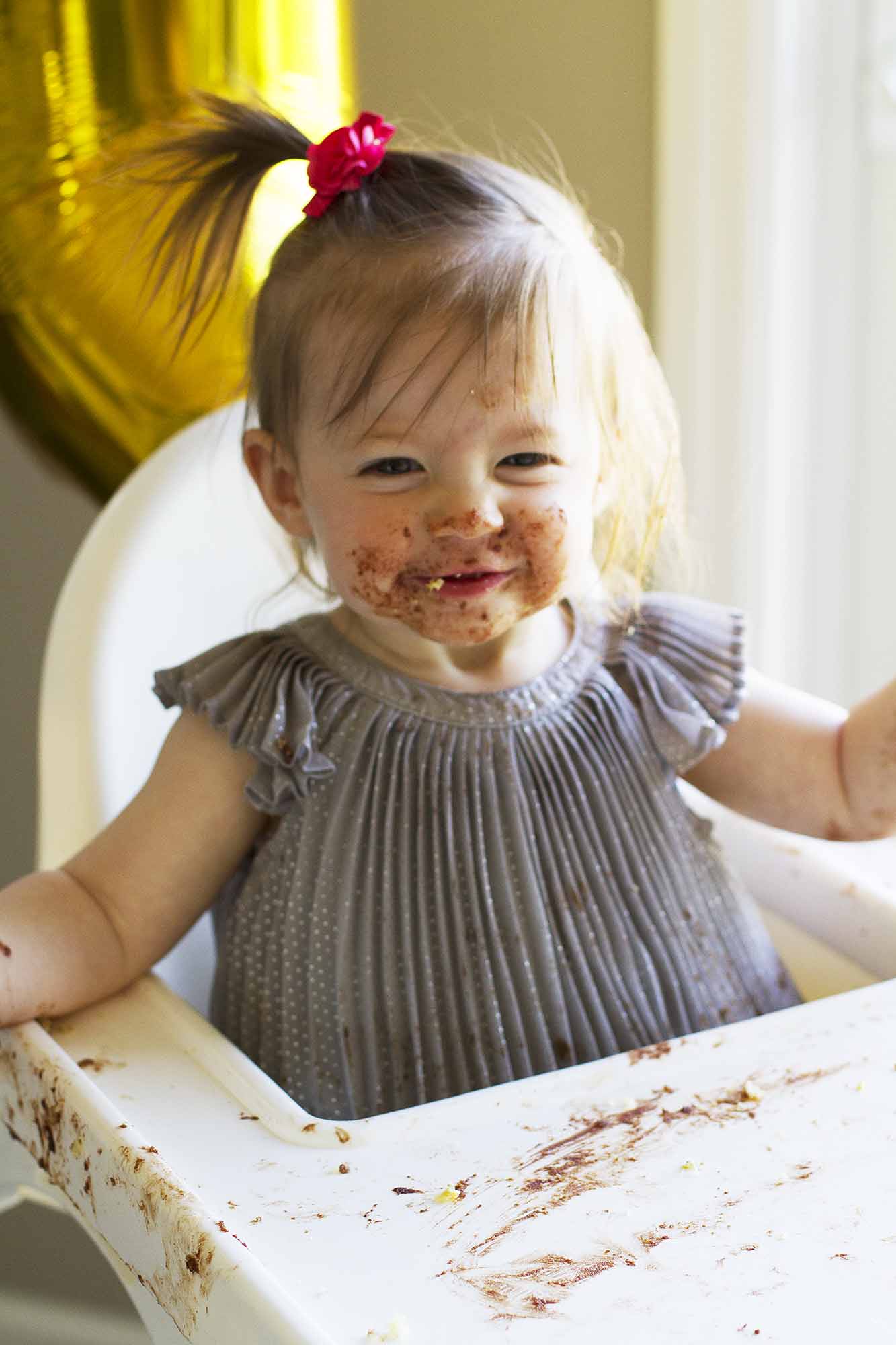 child smiling after eating cake