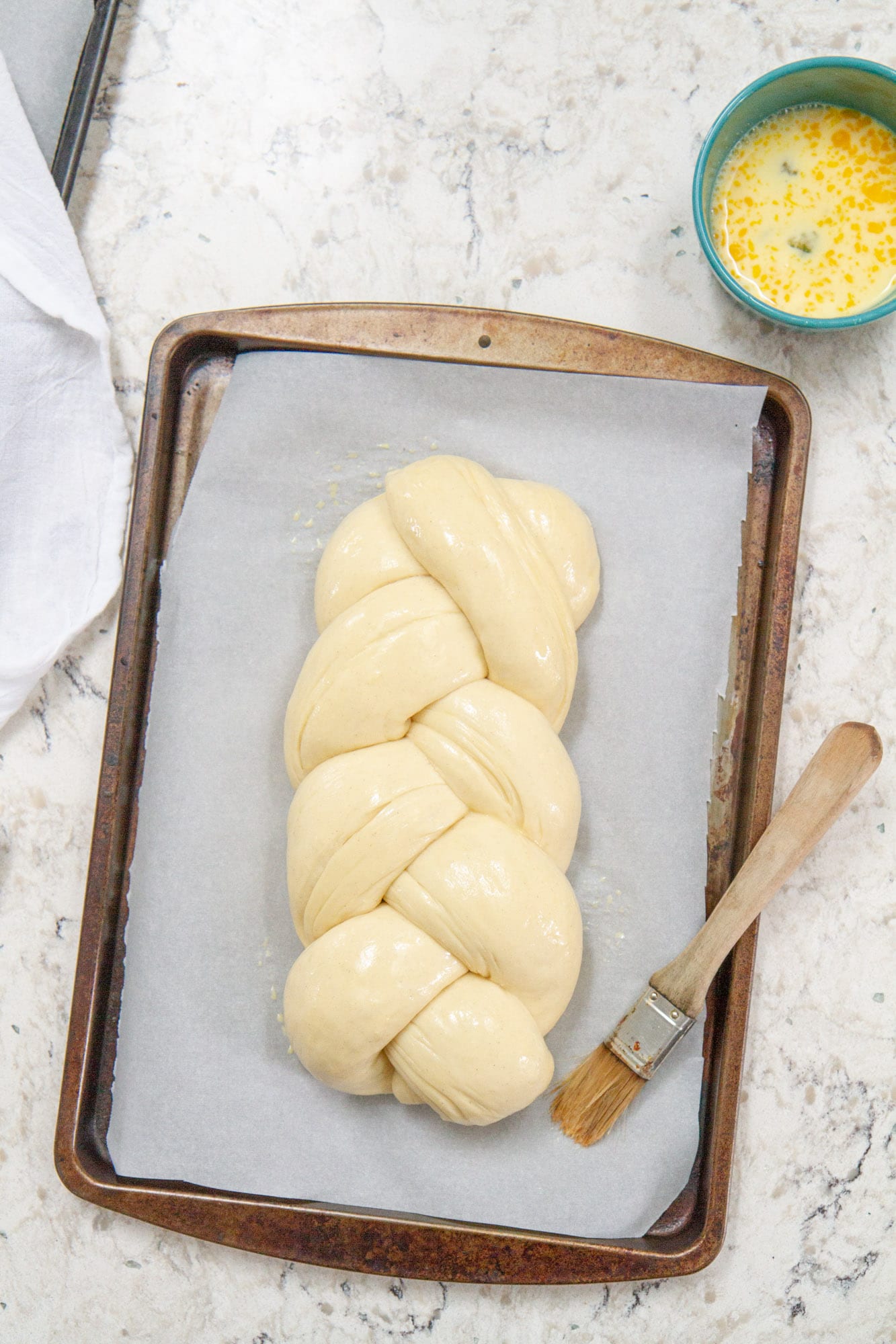 braided cardamom dough on baking sheet