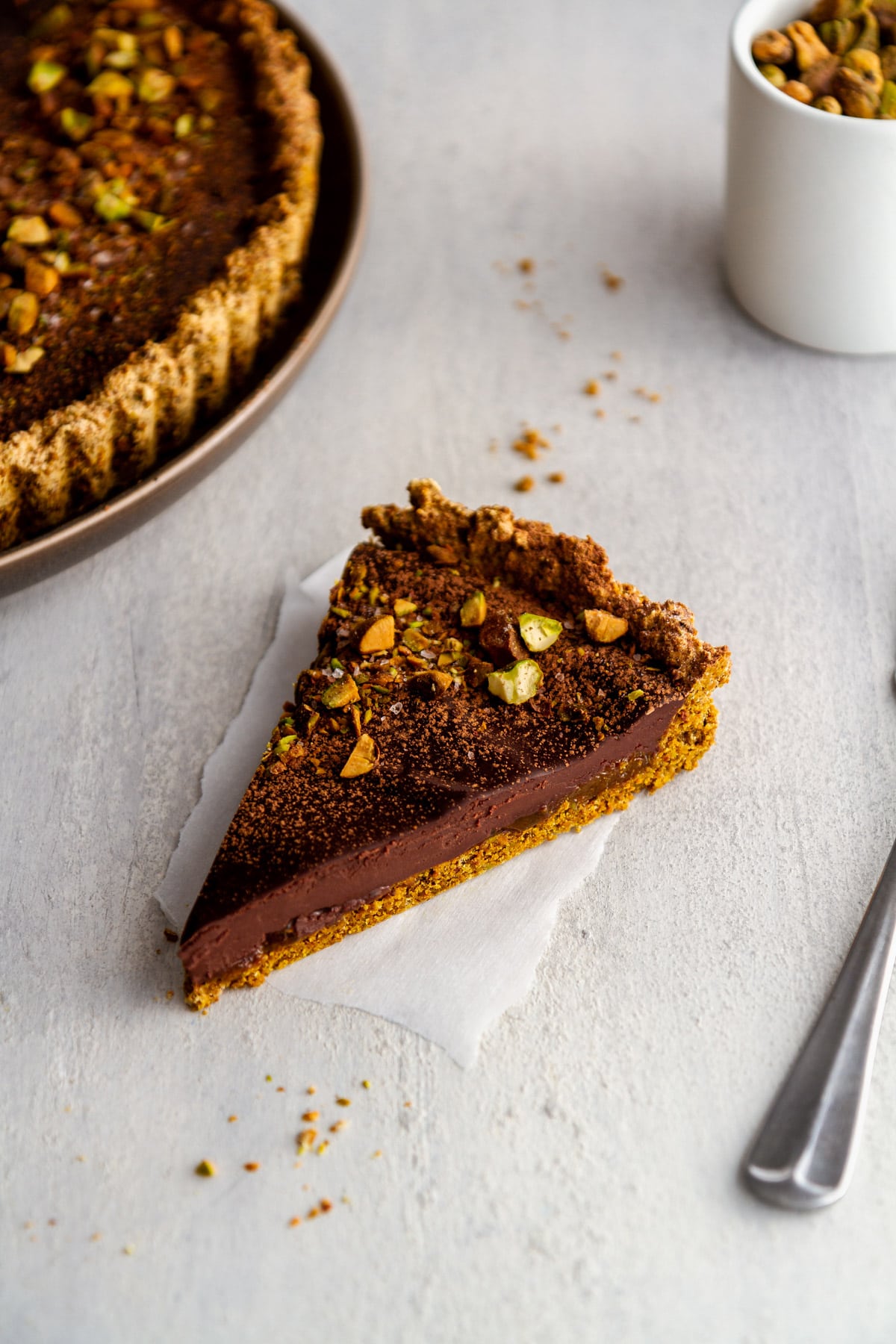 a slice of a chocolate tart on a surface