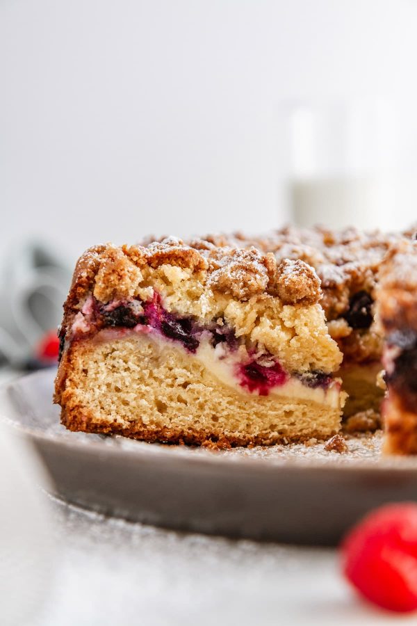 a close-up shot of a slice of berry cream cheese coffee cake