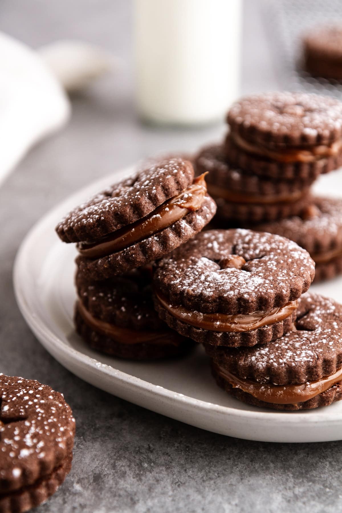 a stack of chocolate alfajores on a plate