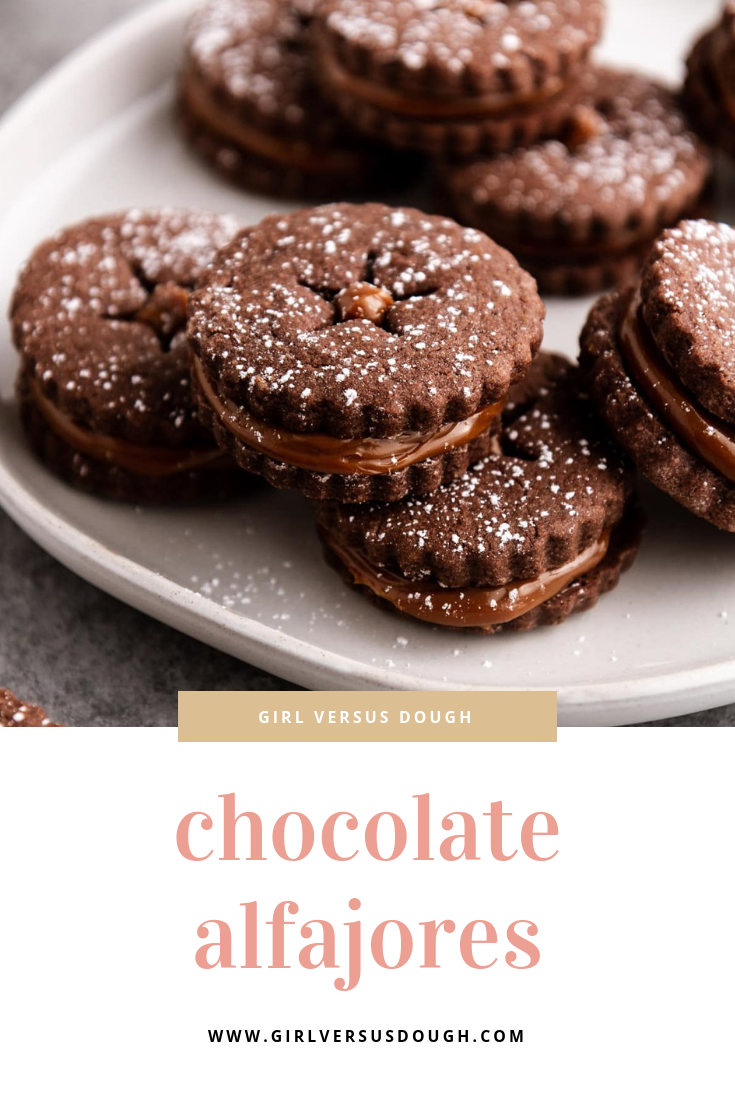 Chocolate Alfajores (Caramel Cookies) -- dulce de leche sandwich cookies with brownie-like chocolate roll-out cookies. Simple, yet so decadently delish. @girlversusdough #chocolatecookies #easycookiesrecipe #easydessert