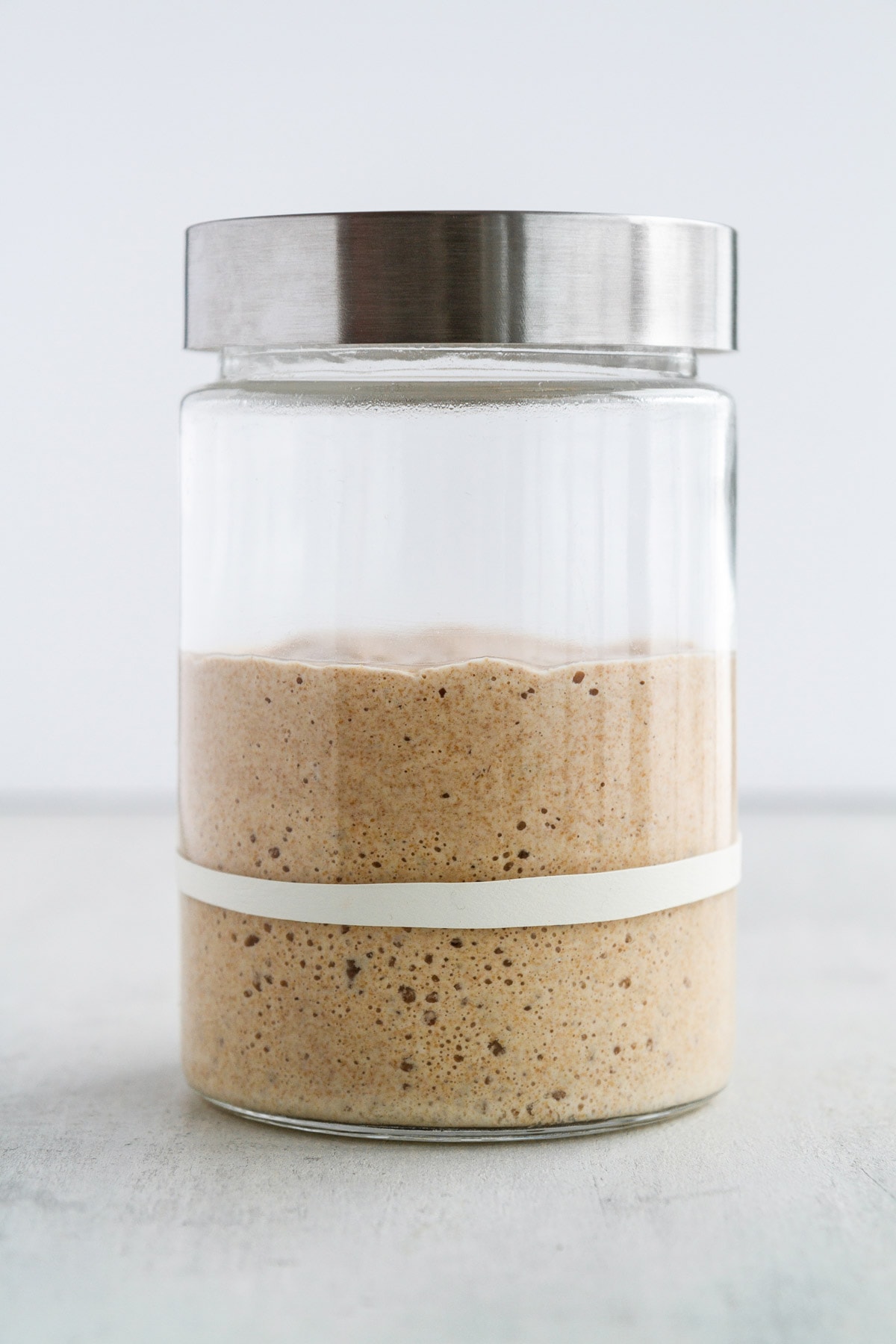 a levain for sourdough at its peak in a jar