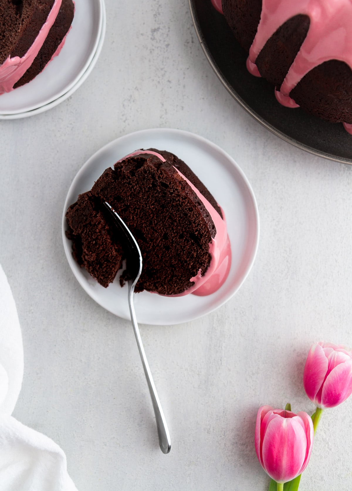 a slice of chocolate bundt cake on a plate with a fork