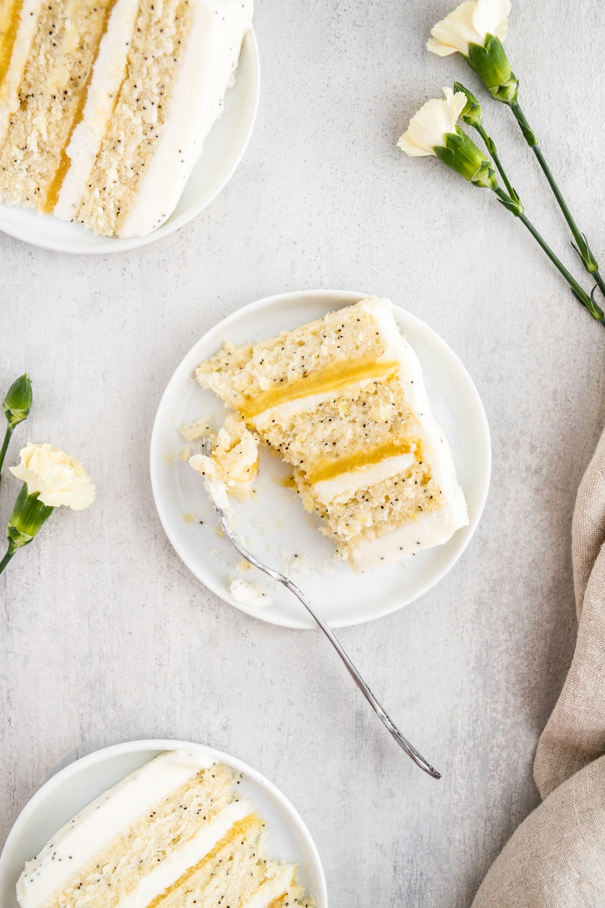 slices of lemon poppy seed cake on plates with a fork