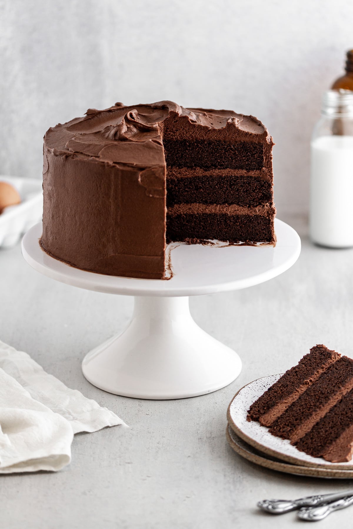 Devil's Food Cake on a cake stand with a slice taken out