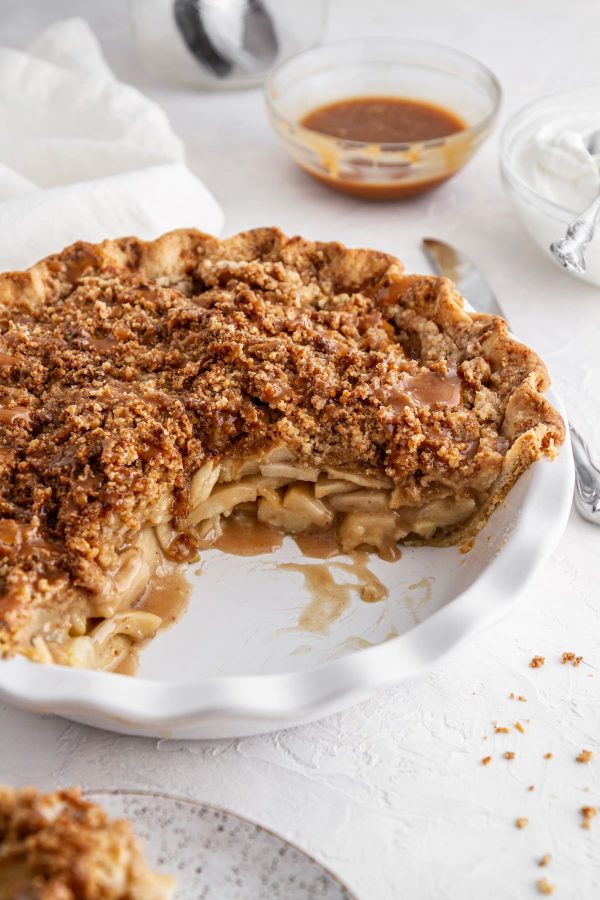 Dutch caramel apple pie in a pie plate with a slice taken out