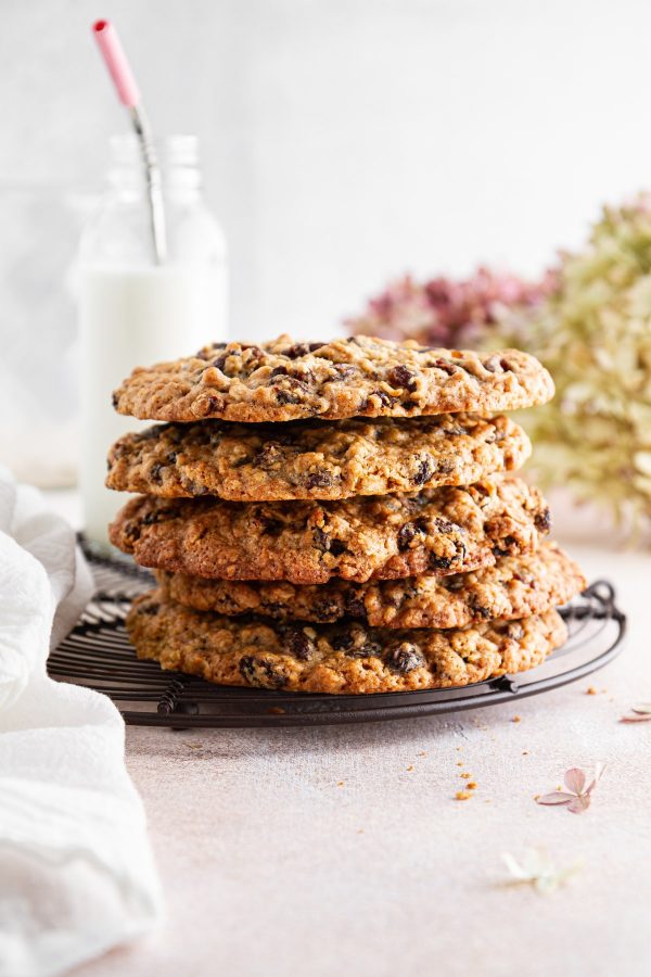 stack of giant oatmeal-raisin cookies on a cooling rack