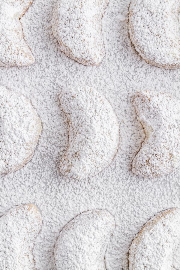 chai-spiced crescent cookies on a sheet of parchment paper