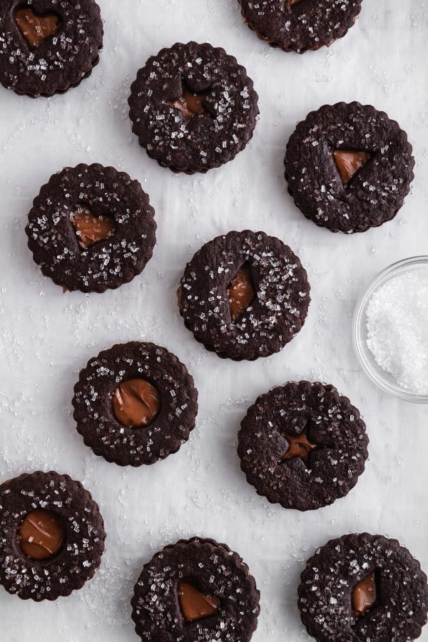 chocolate nutella linzer cookies on a sheet of parchment paper