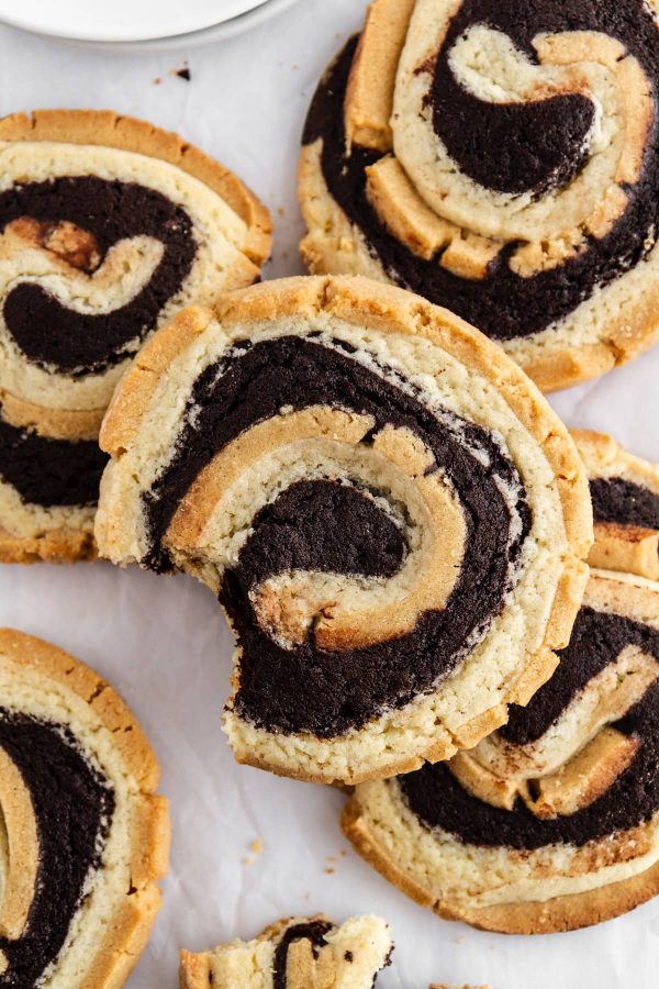peanut butter brownie swirl cookies stacked on parchment