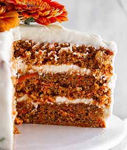 close-up of slice of carrot cake on a cake stand