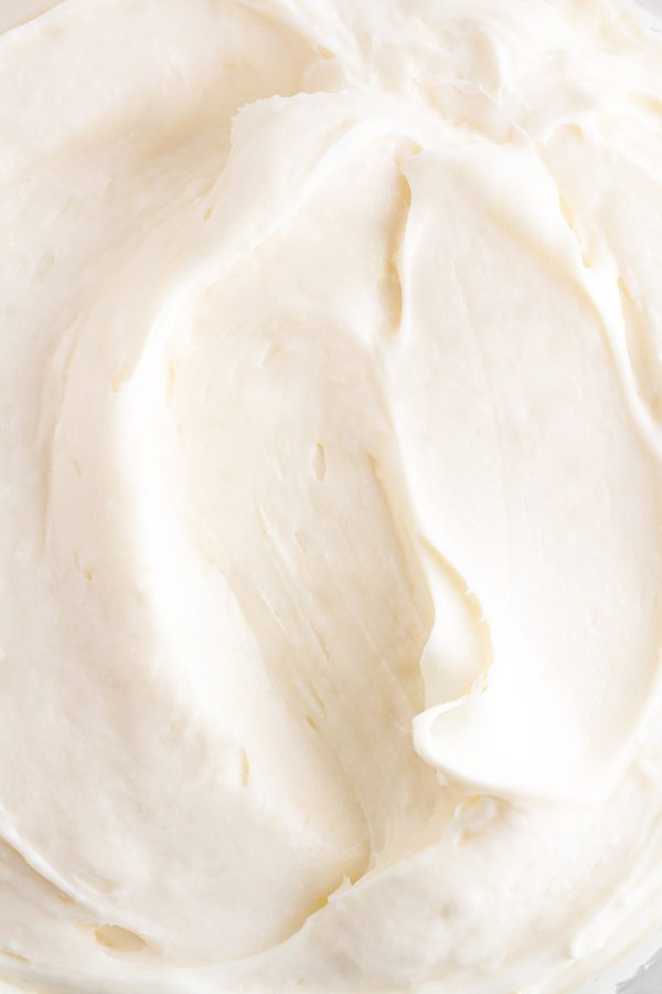 close up shot of cream cheese frosting in a bowl