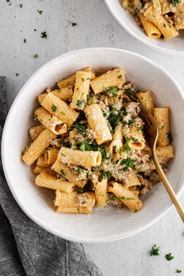 overhead image of creamy rigatoni with sausage and fennel in a bowl