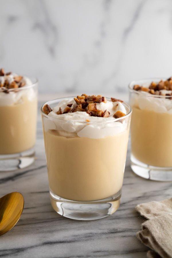 glasses of butterscotch pudding on a surface