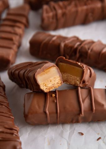 twix bar cut in half on a sheet of parchment paper