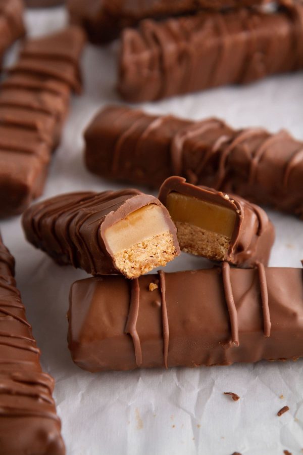 twix bar cut in half on a sheet of parchment paper