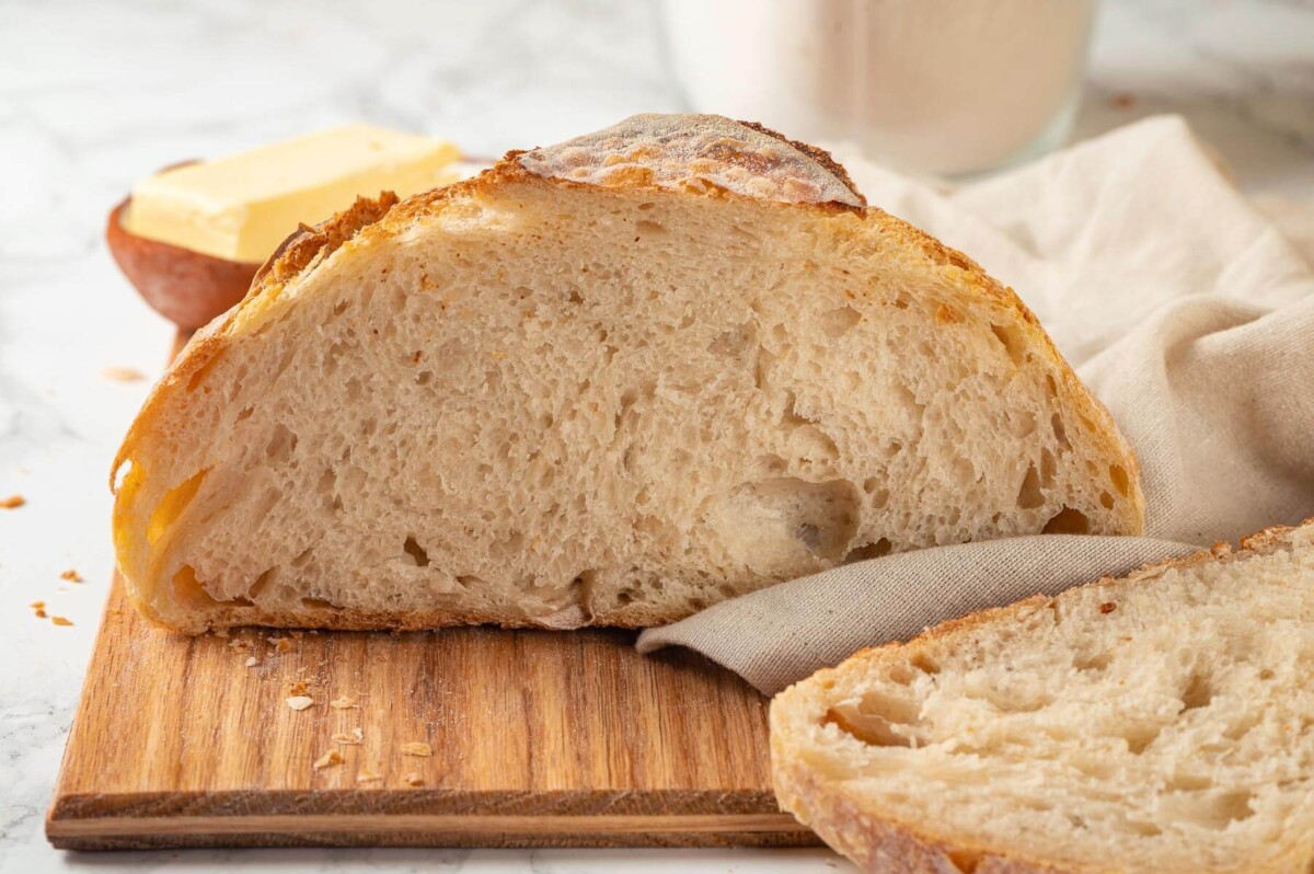 Close-up of sliced sourdough showing an airy, open crumb.